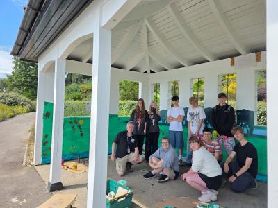 GCSE art students with teachers in garden pavilion