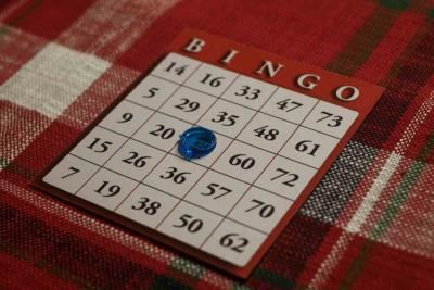 a photo of a bingo board on top of a Christmas inspired tablecloth