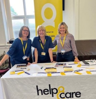 Help and care team with display table at an event