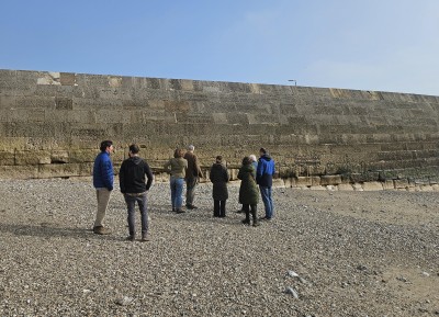 Representatives next to The Cobb harbour wall on a recent site visit