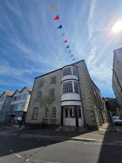 Former Three Cups Hotel in Broad Street on a sunny day with bunting