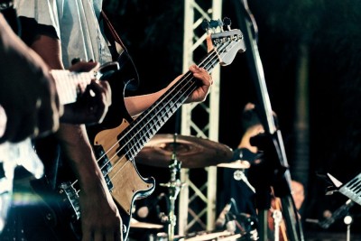 a closeup photo of a guitar from a band playing 