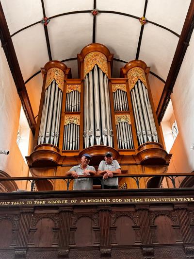 town council maintenance staff on the balcony in front of the famous organ in the church