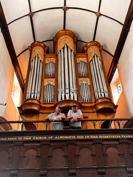town council maintenance staff on the balcony in front of the famous organ in the church