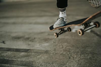 an abstract image of a skateboarder showing only the one foot on the board in the top right corner
