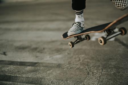 an abstract image of a skateboarder showing only the one foot on the board in the top right corner