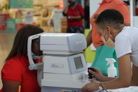 a photo of a lady within a hospital examining a patients eyes