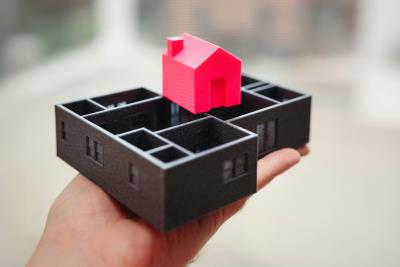 Black wooden housing blocks with a pink wooden house block on top