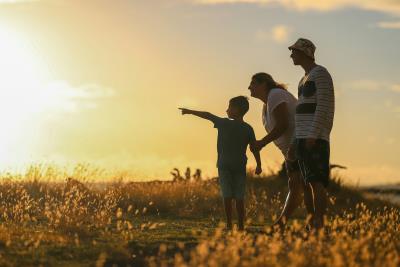 family at sunset looking toward the horizon