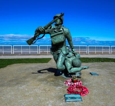 statue of soldiers with poppy wreaths