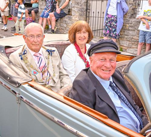 Mayor and mayoress lead the Lyme Regis carnival procession in vintage car