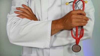 Close up of doctor in white coat with stethoscope