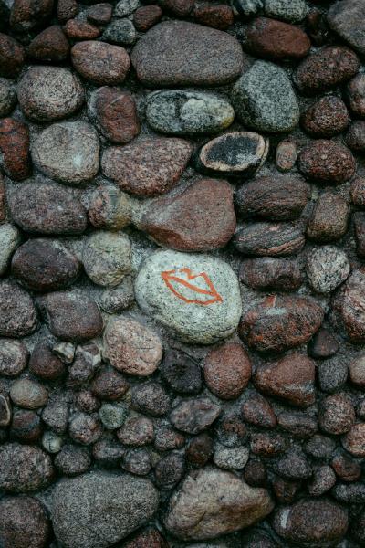 an image of Purbeck stones stacked together to make a wall and one painted with some lips