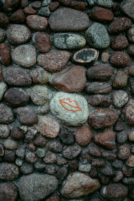 an image of Purbeck stones stacked together to make a wall and one painted with some lips