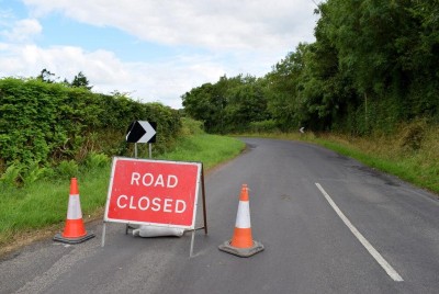 Road Closure sign on road with grass bank on the left