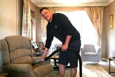 Rob Emery cleaning upholstery at his day job