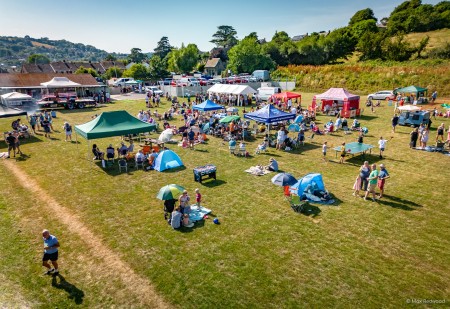 stalls and festival goers enjoying themselves on the football pitch
