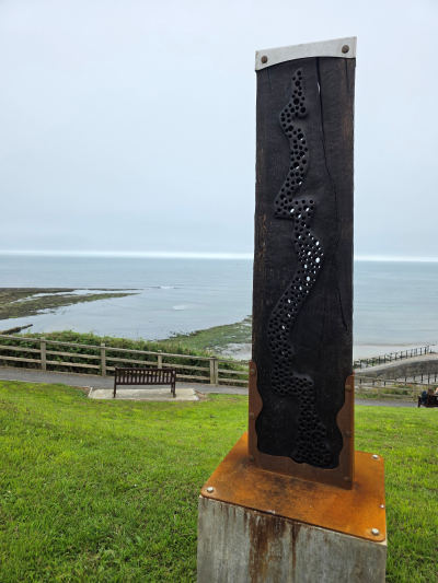 new sculpture carved in oak and charred black, with metal work that will rust orange