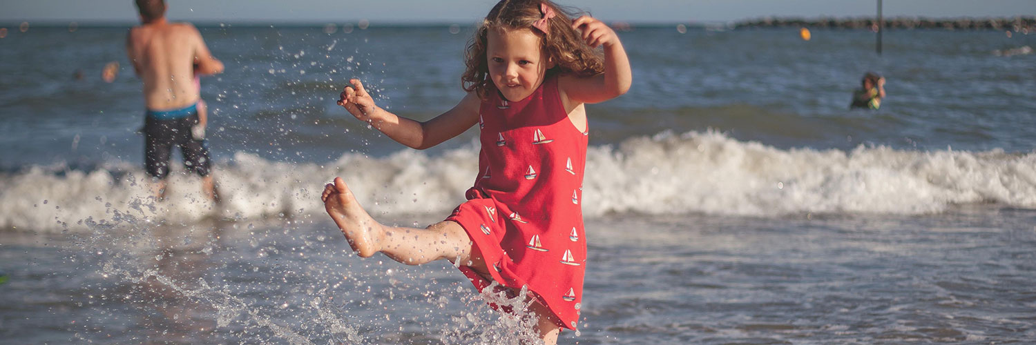 Girl kicking sea water