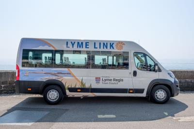 a photo of the Lyme Regis Lyme Link community bus photographed along Marine Parade