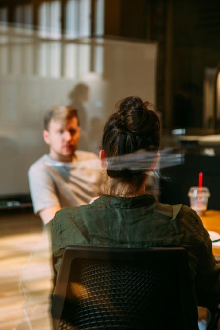 a photo of a man listening to a presentation in a hall