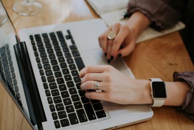a photo of hands working above a laptop keyboard